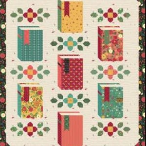 May include: A quilt featuring a repeating pattern of colorful, stylized books with decorative floral accents. The books have various patterned covers in shades of red, green, yellow, and floral prints. The text "Novel Idea" is at the top.