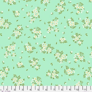 May include: A light green fabric with a repeating pattern of white floral clusters and small green leaves. The flowers have yellow centers. The design is evenly spaced across the fabric.