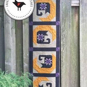 May include: A quilted wall hanging with a crescent moon and cat design. The artwork is 16 inches wide and 58 inches long. The design features a black cat silhouette within a yellow crescent moon, with a purple star. The text "CRESCENT CAT" is at the top.