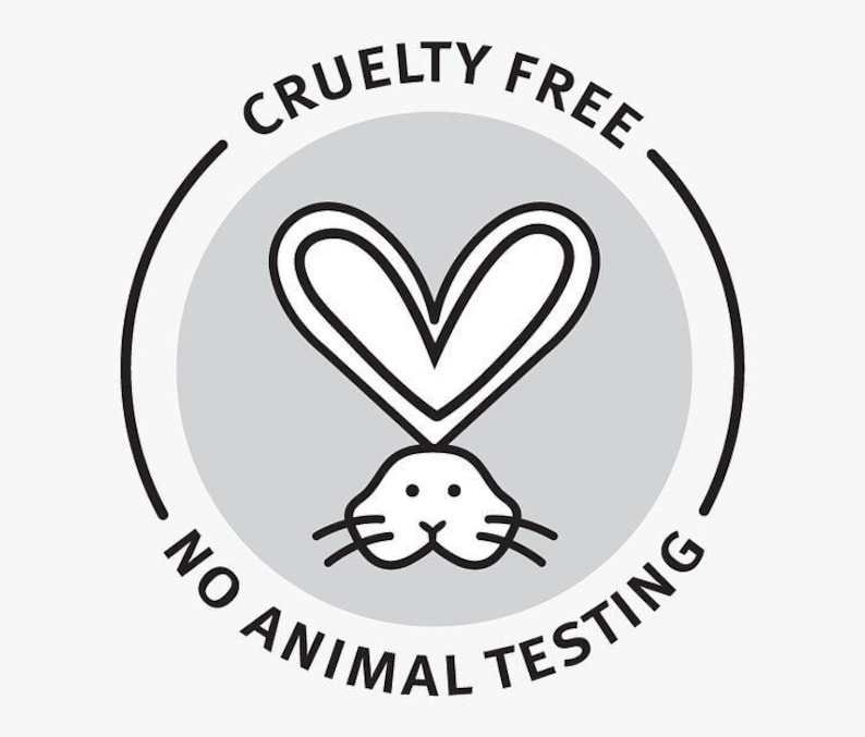 May include: A circular gray and black Cruelty Free, No Animal Testing logo. The logo features a heart shape above a rabbit's head. The words "CRUELTY FREE" and "NO ANIMAL TESTING" are in a circular pattern around the logo.