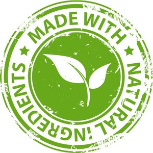 May include: A green circular stamp with the words "MADE WITH NATURAL INGREDIENTS" encircling a central image of two leaves. The stamp has a distressed, worn appearance, suggesting a vintage or handcrafted aesthetic.