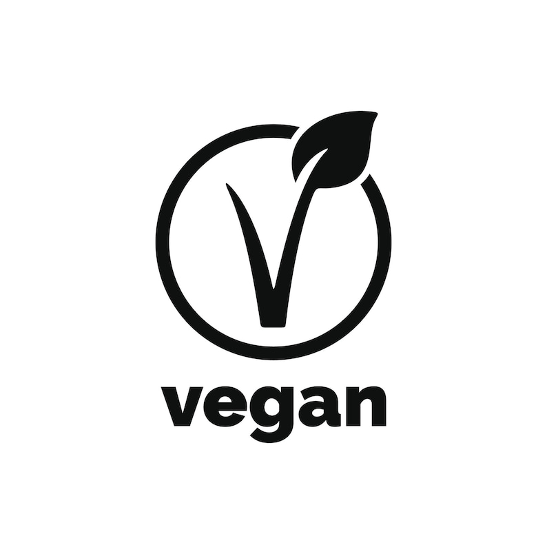May include: A black and white vegan symbol. The design features a stylized leaf and the letter "V" inside a circle, with the word "vegan" below.