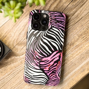 K&ouml;nnte beinhalten: Schwarze und wei&szlig;e Zebra-Print-Handyh&uuml;lle mit rosa Akzenten. Die H&uuml;lle hat eine gl&auml;nzende Oberfl&auml;che und bedeckt die R&uuml;ckseite und die Seiten des Telefons. Die Handyh&uuml;lle hat eine Multi-Objektiv-Kamera.