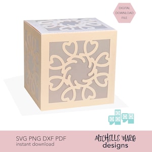 May include: A light beige paper cube with intricate floral cutouts on each side. The cube has a digital download file label and the text "SVG PNG DXF PDF instant download" and "Michelle Ward designs".