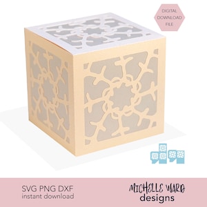 May include: A light beige paper cube with intricate cut-out floral patterns. The cube has a white interior, creating a contrast with the beige exterior. Text on the image reads "DIGITAL DOWNLOAD FILE" and "SVG PNG DXF instant download".