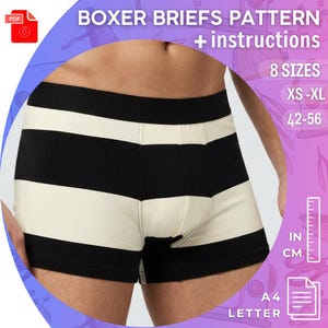 May include: Black and cream-colored striped boxer briefs. The image includes text that reads "BOXER BRIEFS PATTERN + instructions" and "8 SIZES XS-XL 42-56". A ruler with inches and centimeters is also visible.