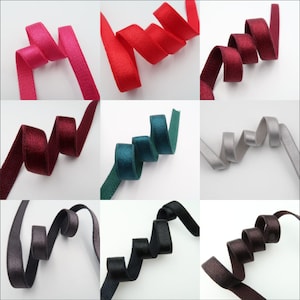 May include: Assortment of 10 colors of velvet ribbon trim. The ribbon is approximately 1 inch wide and has a soft, plush texture. The colors include red, pink, burgundy, teal, gray, black, brown, and more.