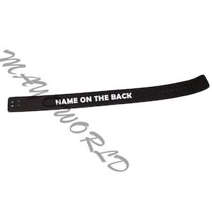 May include: Black weightlifting belt with white text that reads "NAME ON THE BACK".