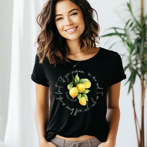 May include: Black t-shirt with a lemon graphic and the text "If you bear much fruit, you will remain in me, and I in you." John 15:5.
