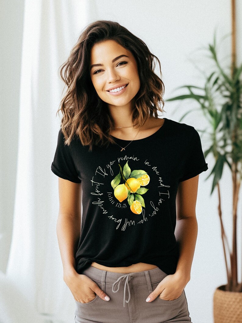May include: Black t-shirt with a lemon graphic and the text "If you bear much fruit, you will remain in me, and I in you." John 15:5.