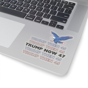 May include: A sticker with a blue eagle flying with red, white, and blue accents. The sticker has the text "TRUMP THEN 45", "TRUMP THEN 45", "TRUMP NOW 47", "TRUMP THEN 45", and "TRUMP THEN 45" in a white, pink, and blue font.