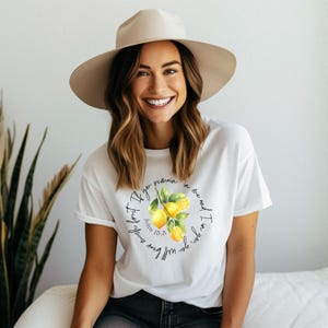 May include: White t-shirt with a lemon graphic and the text "If you remain in me and I in you, you will bear much fruit" John 15:5