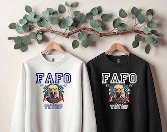 May include: Two sweatshirts with a white eagle graphic and the text "FAFO 45 47 TRUMP". One sweatshirt is white and the other is black.