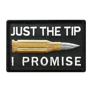 May include: Black embroidered patch with white text that reads "Just the tip I promise" and a gold and silver bullet in the center.