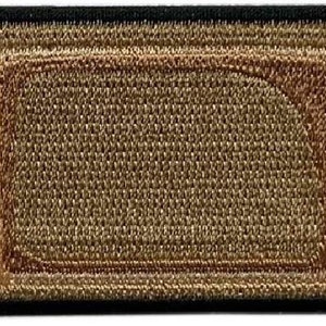 May include: A brown fabric patch shaped like a bandage with a white border and a brown center. The patch has a textured surface and is designed to look like a real bandage.