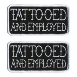 May include: Two black and white embroidered iron-on patches with white stitching. The patches are rectangular and have the text "Tattooed and Employed" in a stylized font.