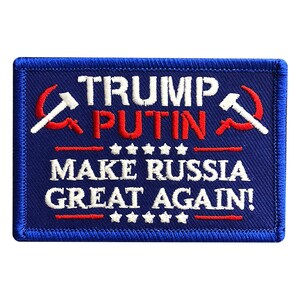 May include: A blue embroidered patch with the text "TRUMP PUTIN MAKE RUSSIA GREAT AGAIN!" in white and red lettering. The patch features a red hammer and sickle on either side of the text.