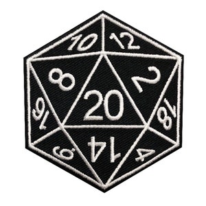 May include: Black and white embroidered patch of a twenty-sided die, also known as a d20. The die has numbers 1, 2, 4, 6, 8, 10, 12, 14, 16, 18, and 20 on its faces.
