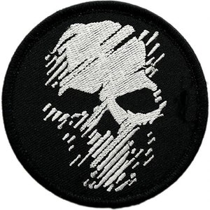 May include: A black embroidered patch featuring a white skull design. The skull is stylised with a series of lines that create a striped effect.