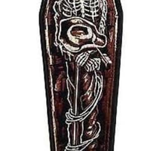Könnte beinhalten: Ein brauner Sarg-förmiger Patch mit einem weißen Skelett, das einen Pinsel und eine Farbpalette hält. Das Skelett befindet sich im Sarg und ist von weißen Ranken umgeben.