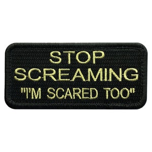 May include: Black embroidered patch with yellow text that reads "STOP SCREAMING "I'M SCARED TOO"