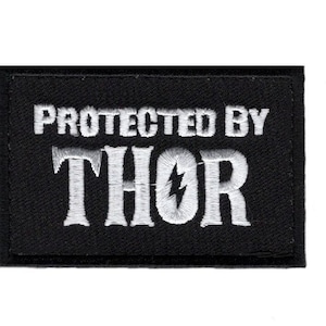 May include: Black embroidered patch with white text that reads "Protected by Thor" with a lightning bolt symbol.
