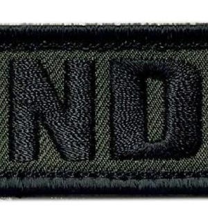 May include: A black and green embroidered patch with the text "SEND IT" in black.
