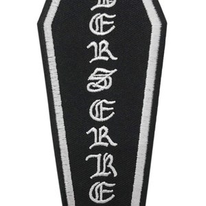 May include: Black and white embroidered coffin-shaped patch with the word "B.E.S.T.R.E.S.T" written vertically in white.