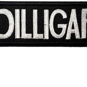 May include: A black embroidered patch with white lettering that reads "DILLIGAF".