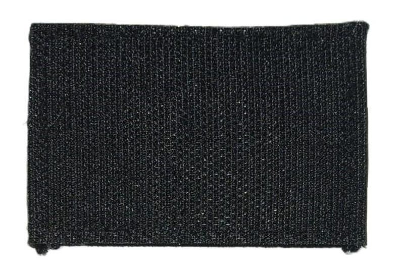 May include: Black hook and loop fastener patch. The patch is made of a textured fabric.