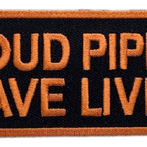 May include: A rectangular patch with the words "LOUD PIPES SAVE LIVES" embroidered in orange on a black background. The patch has an orange border.
