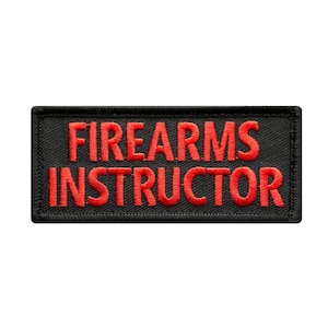 May include: Black embroidered patch with red text that reads "FIREARMS INSTRUCTOR".