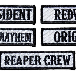 May include: Five white rectangular embroidered patches with black text. The patches read "V. President", "Redwood", "Men of Mayhem", "Original", and "Reaper Crew".