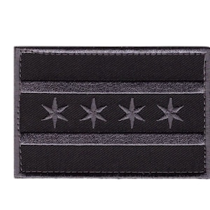 May include: Black and gray embroidered patch featuring the Chicago flag with four white stars on a white stripe.