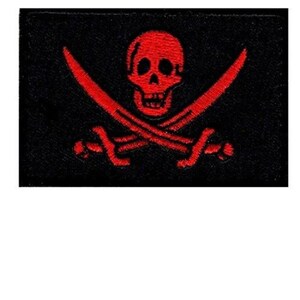 May include: A black fabric patch with a red embroidered skull and crossbones.