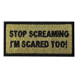 May include: A black and tan embroidered patch with the text "STOP SCREAMING I'M SCARED TOO!"