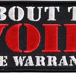 May include: Black embroidered patch with white text that reads "About to Void the Warranty" and a red embroidered word "VOID" in the center.