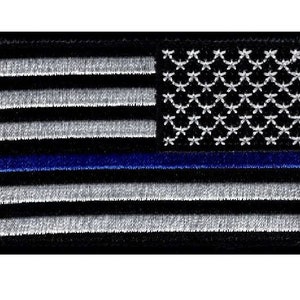 May include: Black and white American flag patch with a thin blue line across the middle. The flag is embroidered with white stars on a black background and white stripes on a black background.