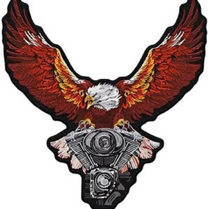 May include: Embroidered patch depicting an eagle with spread wings. The eagle has a white head, yellow beak, and red, orange, and yellow feathers. Below the eagle is a detailed motorcycle engine design, all on a black background.