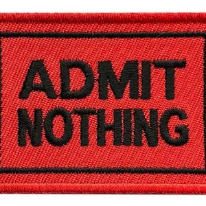 May include: Red fabric ticket patch with black stitching and the text "ADMIT NOTHING" and the numbers "013437" on either side.