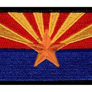 May include: Embroidered patch featuring the Arizona state flag. The flag is red, yellow, and blue with a red star in the center and a yellow sunburst design.