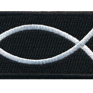 May include: A black fabric patch with a white embroidered Ichthys symbol, also known as the Jesus fish.