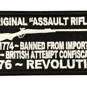 May include: Black and white embroidered patch with a silhouette of a rifle and the text "ORIGINAL "ASSAULT RIFLE" 1774-BANNED FROM IMPORT 1775-BRITISH ATTEMPT CONFISCATION 1776~REVOLUTION"