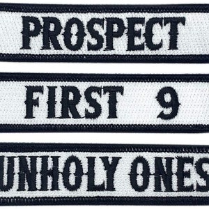 May include: Three white rectangular patches with black text. The top patch reads "PROSPECT". The middle patch reads "FIRST 9". The bottom patch reads "UNHOLY ONES".