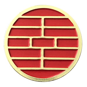 May include: A gold-colored circular pin with a red brick pattern inside. The pin is a traditional Chinese symbol of good luck and prosperity.