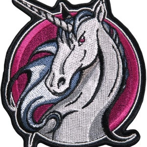 May include: White unicorn head with a silver horn and blue mane, embroidered on a black and pink circular patch.