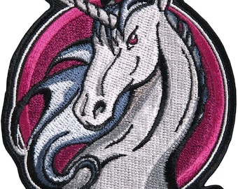May include: White unicorn head with a silver horn and blue mane, embroidered on a black and pink circular patch.