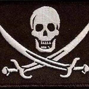 May include: A rectangular embroidered patch featuring a white skull centred above two crossed swords on a solid black background. The design is stitched with white thread, creating a high-contrast graphic of a classic pirate flag emblem.