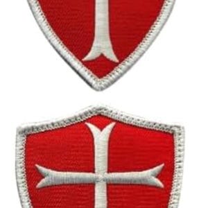 May include: Two red embroidered patches in the shape of a shield with a white cross inside.