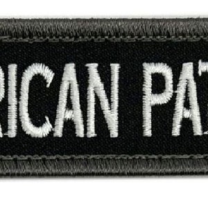 May include: Black embroidered patch with white text that reads "AMERICAN PATRIOT".